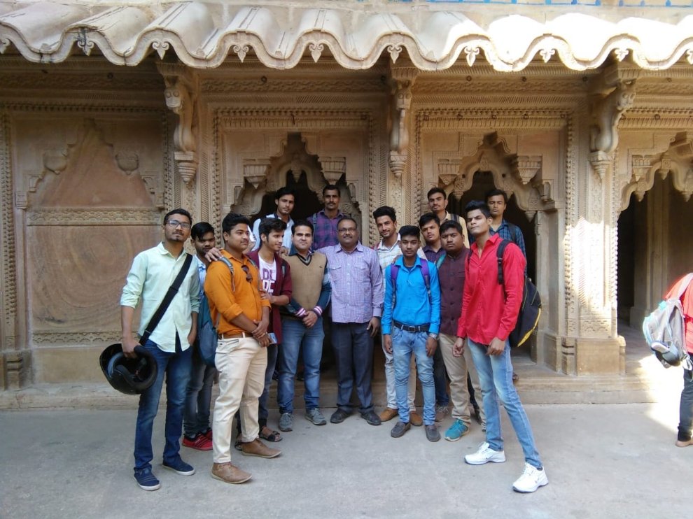 Two table top jars of assorted succulents.
